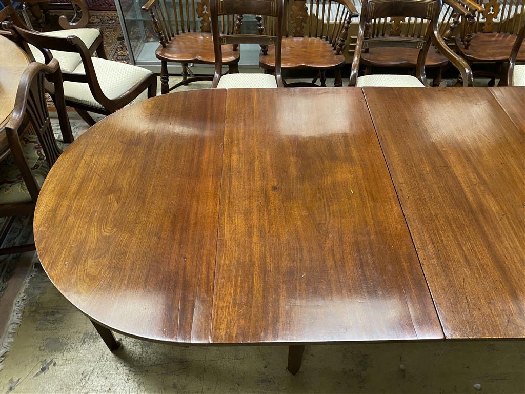 A George III mahogany D end dining table, on square tapered legs, with three spare leaves, 274cm extended, one spare leaf, width 107c